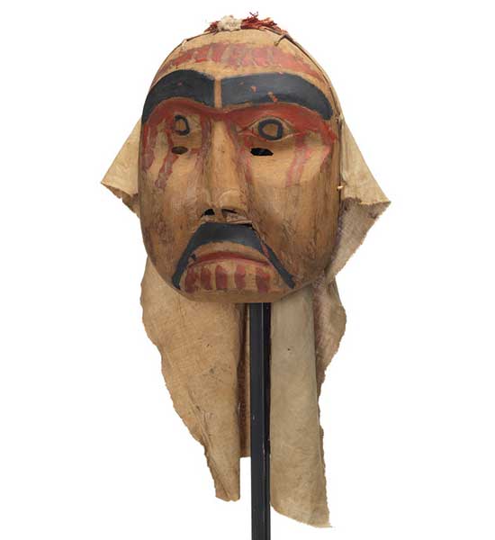 Mourning mask with red paint drips on forehead, cheeks and chin. Black moustache and eyebrows. Eye holes on upper cheek.