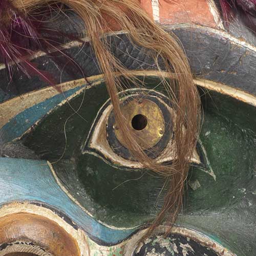 Colour photograph detail view of eye from Bakwas with Snakes mask