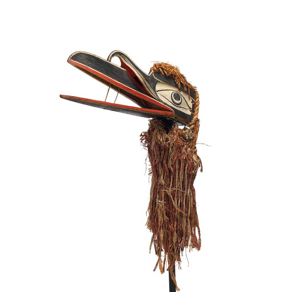 un grand et monstrueux masque de Baxwbakwalanuksiwe’ ceint d'écorce, avec deux bouches, deux becs en saillie, et un petit crâne dans la bouche.