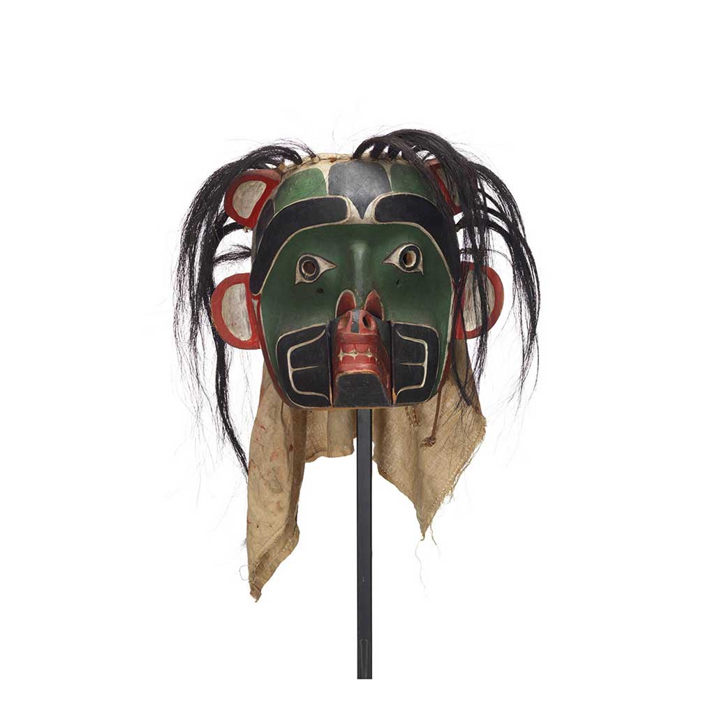 Un Sapagamł, masque d'écho, vert et noir au pourtour blanc et rouge, à embout buccal interchangeable de loup.