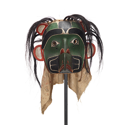 Sapagamł or echo mask, green and black with white red trim, interchangeable mouthpiece shown with wolf.