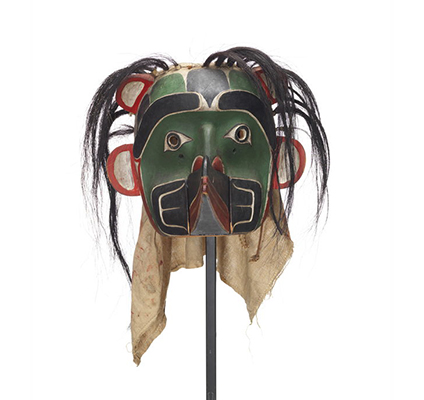 Sapagamł or echo mask, green and black with white red trim, interchangeable mouthpiece shown with raven.