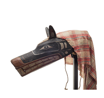Xisiwe’ or wolf mask, one of several with long snout and large teeth, painted red and black with plaid cotton head cover, prominent upright ears