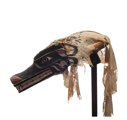 Xisiwe’ or wolf mask, one of several with long snout and large teeth, snarling expression, painted red and black with mottled pattern cotton head cover