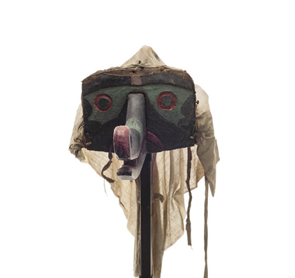 Headdress representing mosquito, black paint with green and red, long projecting proboscis, plain cotton head cover at back.