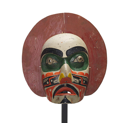'Makwala or moon mask, red painted circular shape surrounds face which is painted white with green patches around eyes, black, orange yellow patterns.