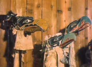 Image shows a group of 3 eagle masks installed in the Potlatch Gallery at U’mista Cultural Centre.