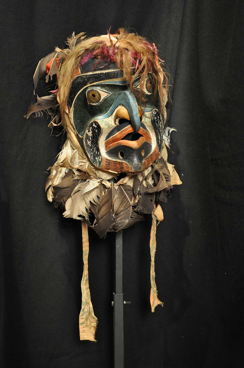 Colour photograph shows Bakwas – Wild Man of the Woods mask shot against a black background