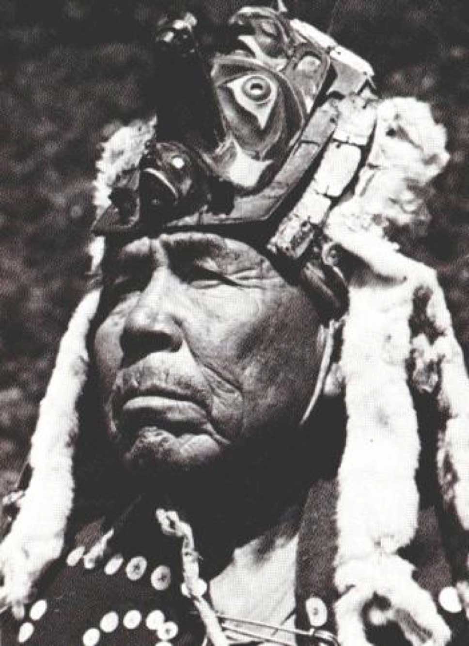 Black and white portrait photograph of Hiłamas, Willie Seaweed shown wearing a chief's headdress with ermine trim