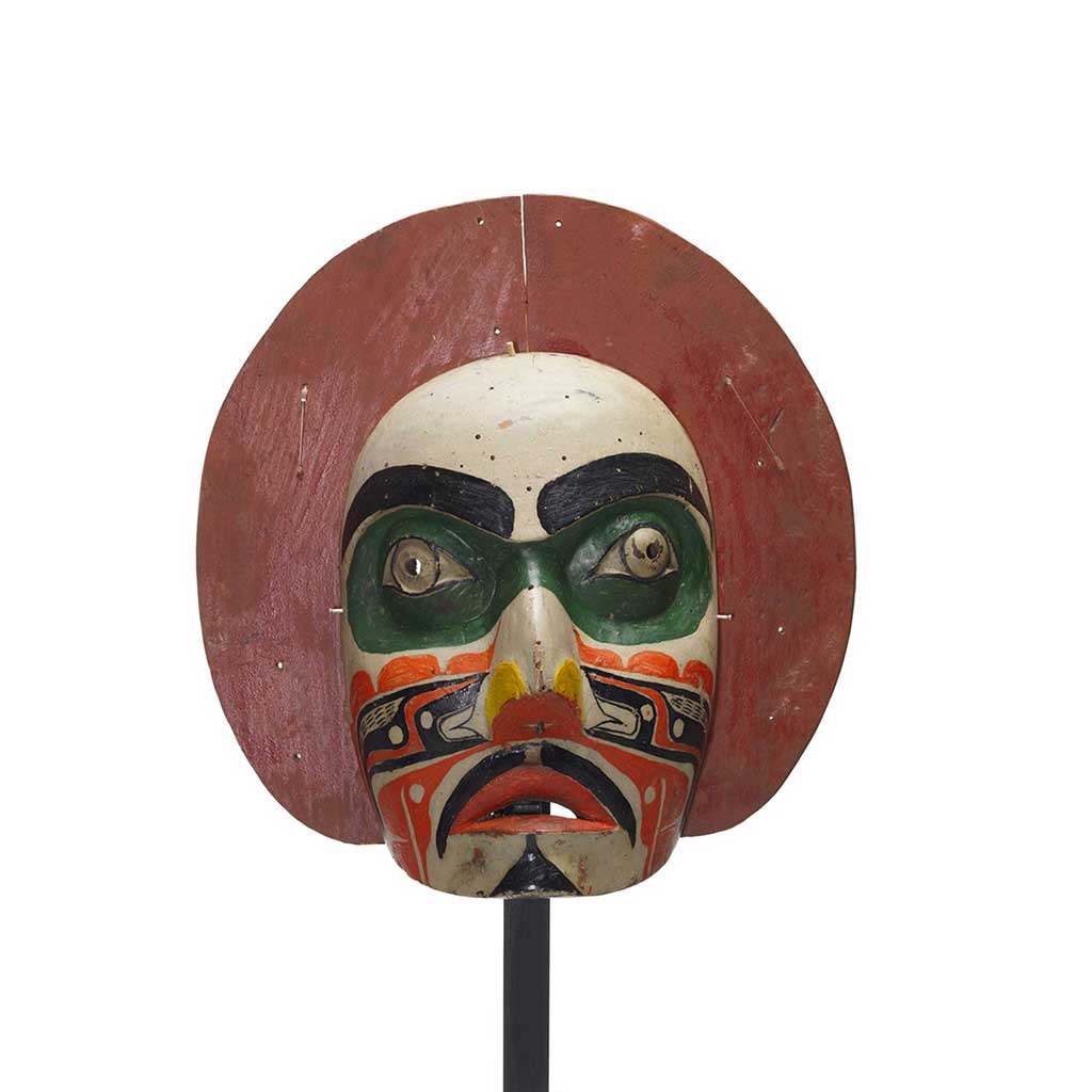 'Makwala or moon mask, red painted circular shape surrounds face which is painted white with green patches around eyes, black, orange yellow patterns.