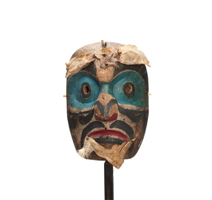 Speaker mask. Bright blue paint around eyes and bridge of nose, black paint markings on forehead, cheeks, nose and lips. Fur attached to brow and chin.